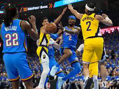 OKC guard Shai Gilgeous-Alexander passes to guard Cason Wallace in Game 2 of the NBA Finals (Christine Tannous/IndyStar)