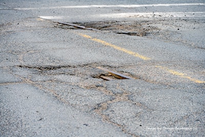 Looking Northeast from Lisgar Street. The pothole closest either has a part of a switch, frog or a guide rail.