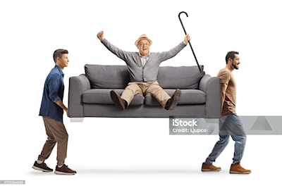 Movers carrying a sofa with a happy elderly man isolated on white backgroun