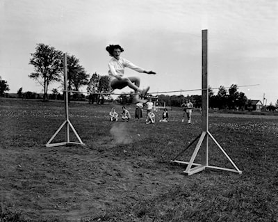 Donna Smith clearing the high jump at the Acton High School Field Day -- June 1958