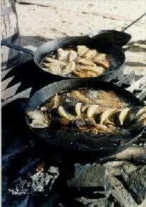 Cast Iron over a camp fire when fishing with a crew of buddies.