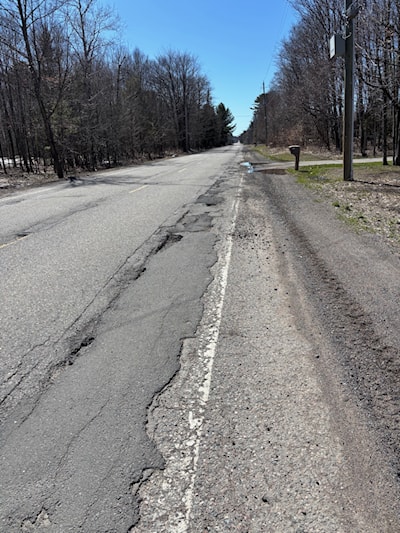In the distance there are potholes full of water