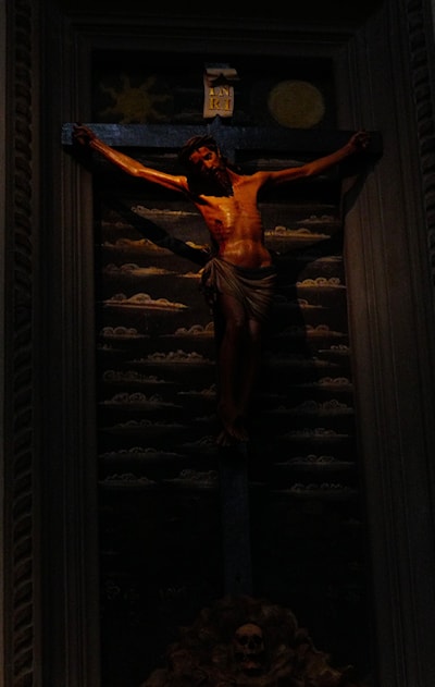 At the back of a church, hidden in the dark
