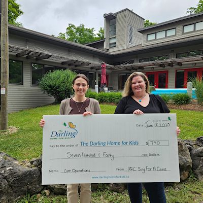 Robin from Active Results Collaborative presents cheque to Julia at The Darling Home for Kids.
