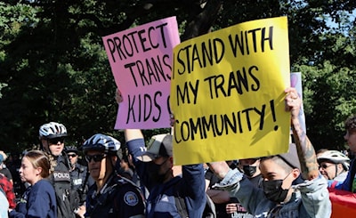 Protestors hold signs showing support for trans people during a Toronto rally on Sept. 20, 2023.Gabe Oatley/Supplied